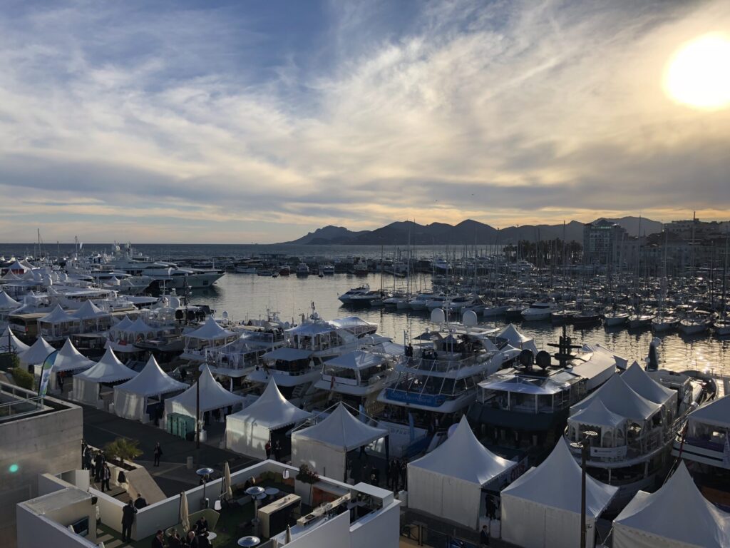 Marina with boats and tents at sunset.