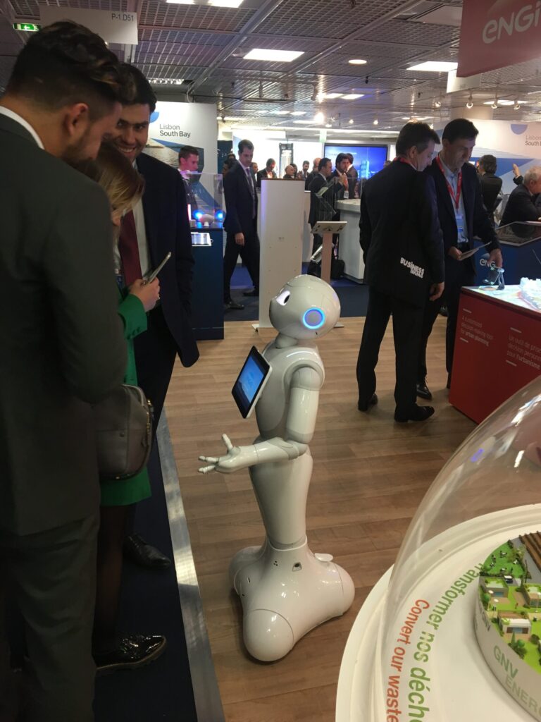 Robot interacting with people at a conference.